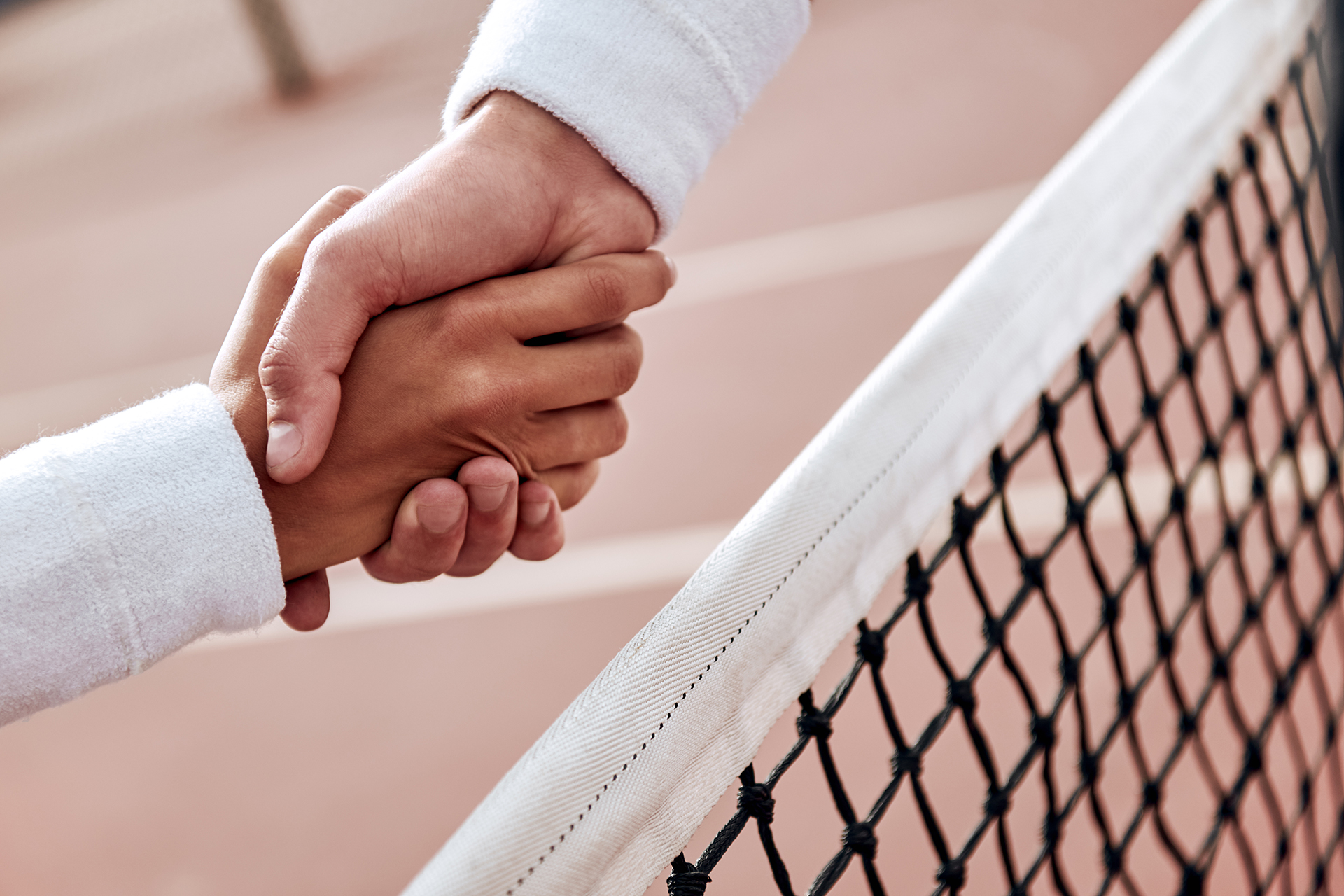 Two tennis players are shaking hands